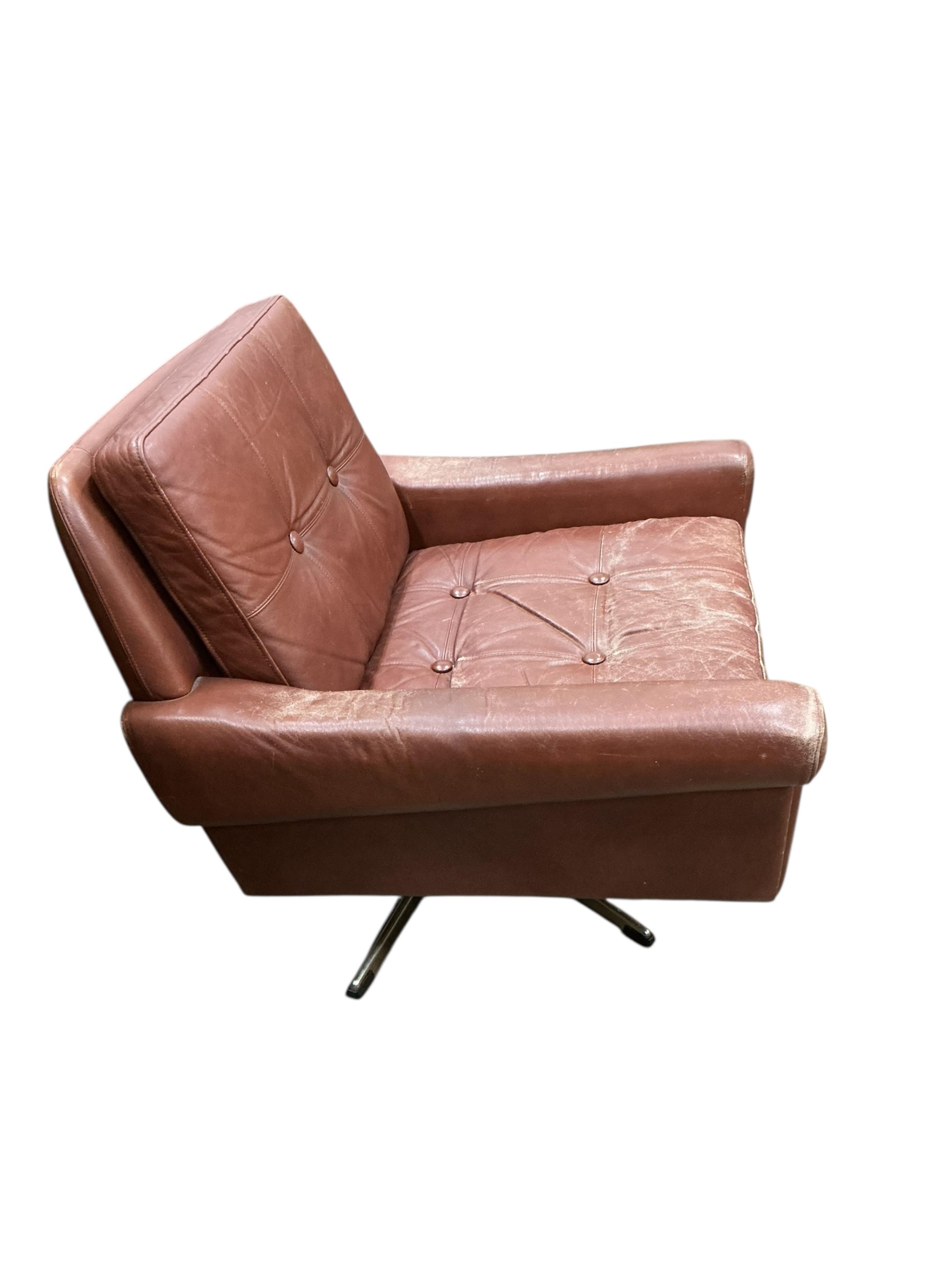 A Danish mid century Svend Skipper brown leather swivel lounge chair on five prong chrome base, width 74cm, depth 76cm, height 70cm